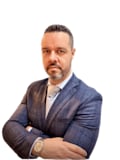 E. Tim Karkatselos